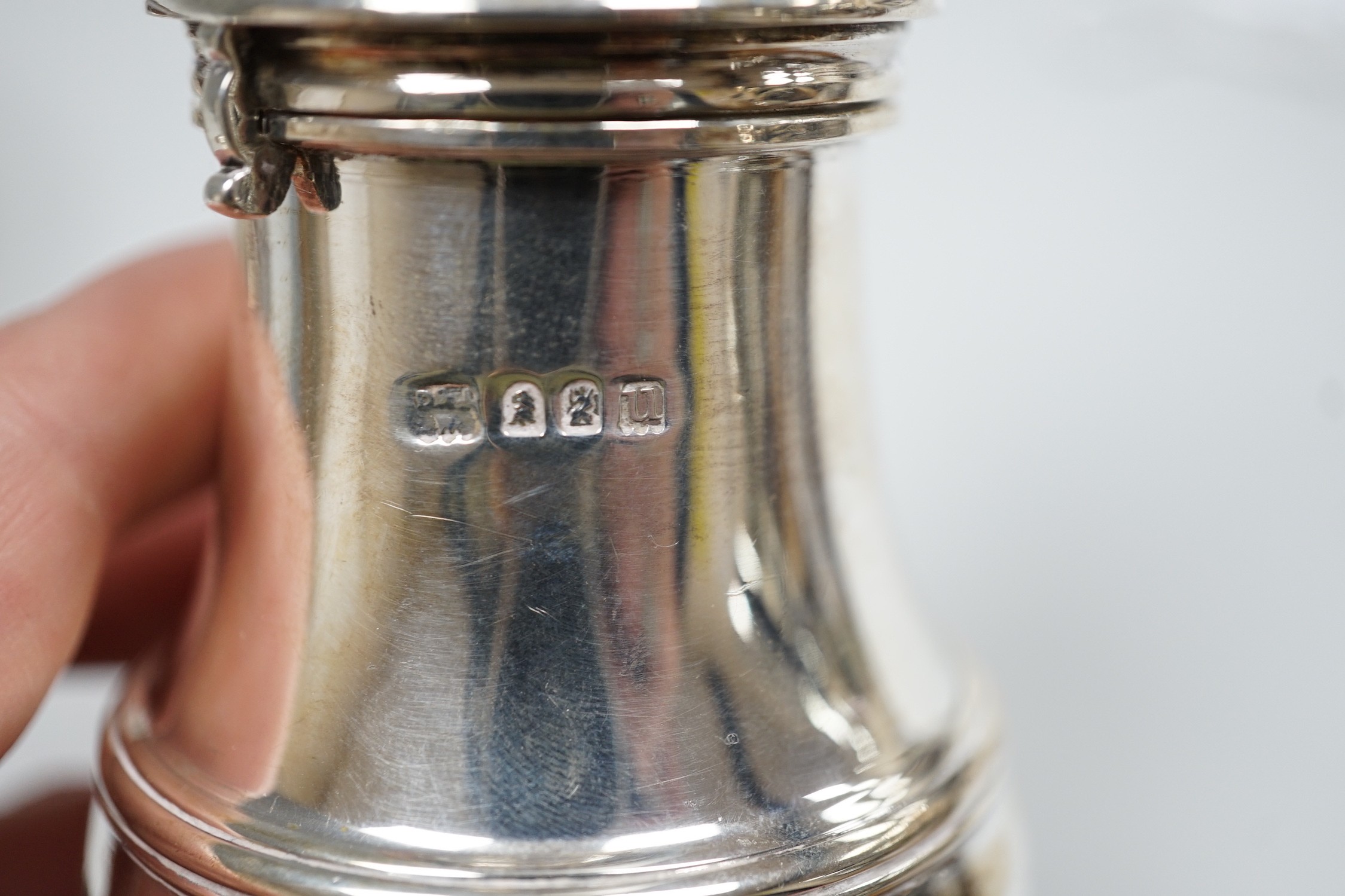 A George V Brittania standard silver baluster sugar caster, Daniel & John Welby, London, 1915, 15.7cm, a modern silver mounted wine coaster and a plate novelty bowler hat dish.